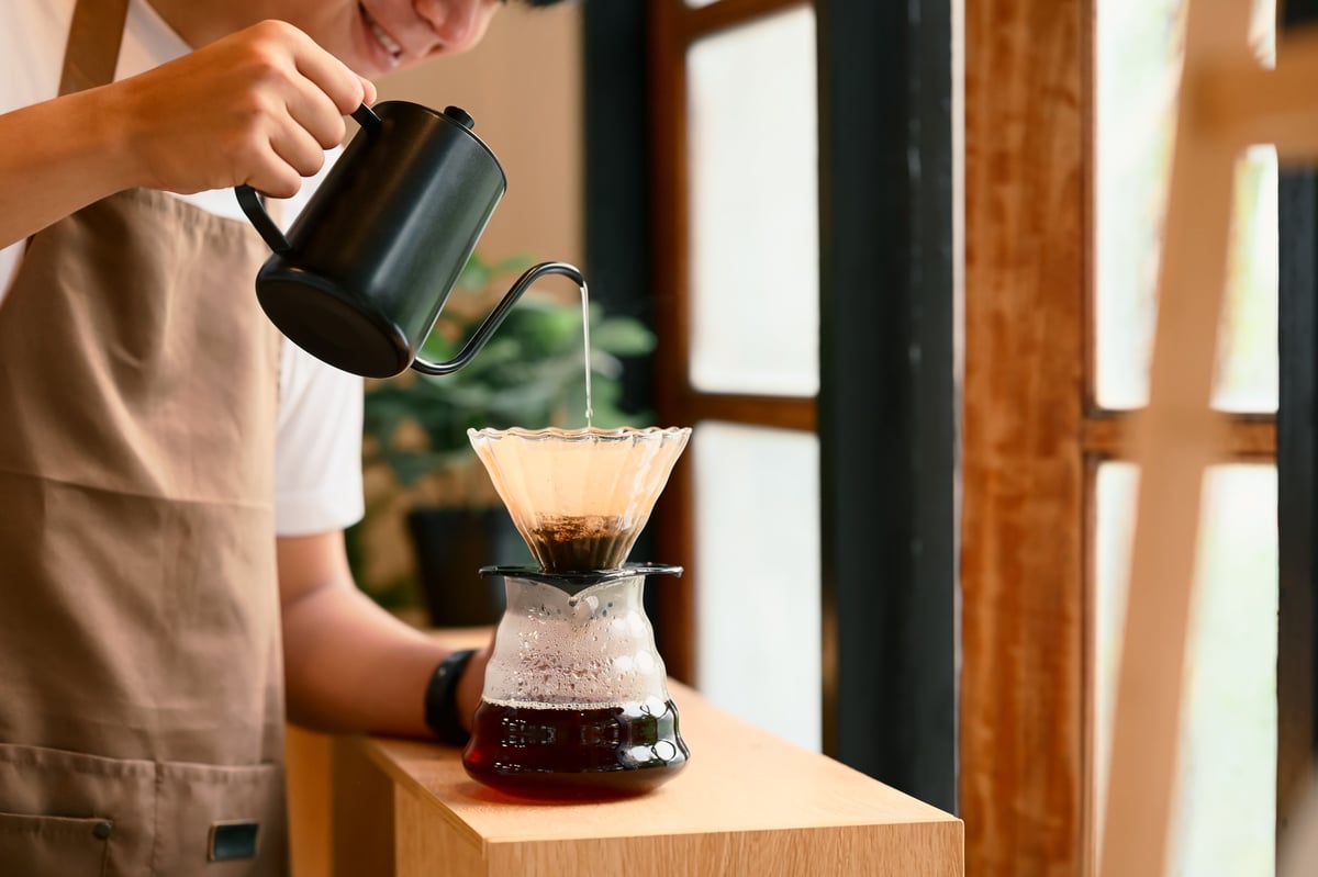 Relaxed host pouring coffee